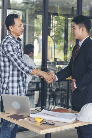 Photo for Teamwork partner two men team shaking hands together. Businessman contractor handshake with Business Partner Trust Partnership. Industrail people contractor dealing mission team meeting office desk - Royalty Free Image