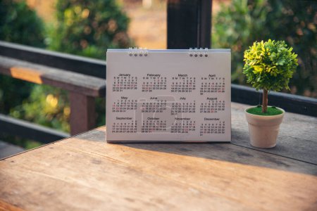 2024 Calendar event planner timetable agenda plan on organize schedule event. Wedding planner agenda organizing timetable by organizer schedule. Calendar desk objects on office table in green park