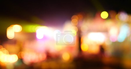 Photo for Vibrant Bokeh abstract blurred background music festival stage show performance party. Colorful bokeh background spark animate motion. Backdrop display with twinkling night life shape blinking light - Royalty Free Image