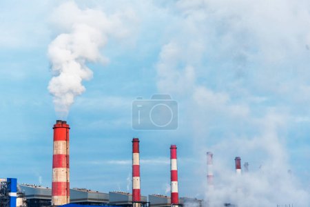 Photo for Power stations manufacturing electrical industrial plant. Electric power building refinery engineering smog steam smokestack. Lignite electricity chimneys release pollution in industry plant blue sky - Royalty Free Image