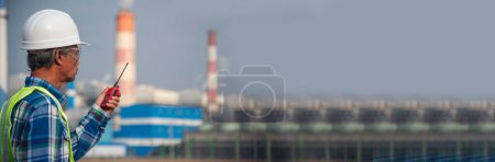 Photo for Panorama Technician blue hard hat helmet Engineer industry with copy space. Banner Senior Electrician engineer man hand holding red Walkie talkie wear White hardhat at Power plant electrical stations - Royalty Free Image