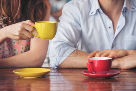 Young couple talking in cafe coffee shop happy date couple communication positive relationship while relaxing in cafe drinking coffee and talkative. Valentine's day concept.