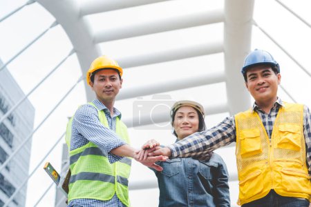 Group of multiracial people Teamwork meeting join hands Engineer Manager Foreman fist bump together. Close up diversity engineer people hands partner teams. Business connection team join partnership