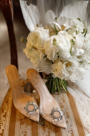 Téléchargez les photos : Chaussures de mariage et bouquet de mariée sur une chaise vintage - en image libre de droit