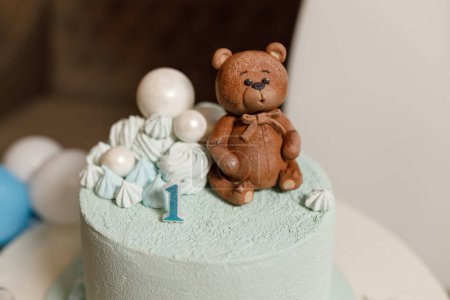 Celebratory cake for a children's birthday in blue with a teddy bear