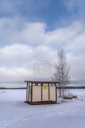 Photo for Wooden changing room cabin at the Finnish beach in winter. Hollola, Finland. - Royalty Free Image