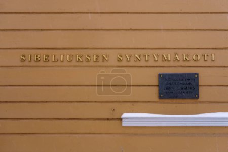 Photo for A sign saying Birthplace of Jean Sibelius in Finnish on the wall of the childhood home of the Finnish composer. Hameenlinna, Finland. February 23, 2023. - Royalty Free Image
