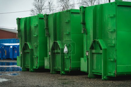 Photo for Large green waste containers on gravel - Royalty Free Image