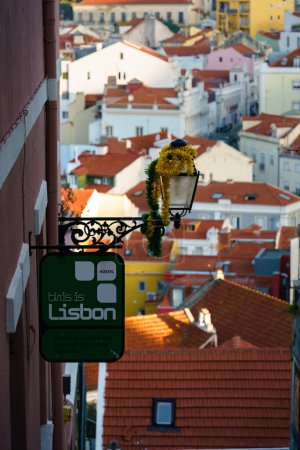 Photo for This is Lisbon - hostel sign Against a Backdrop of Traditional City Rooftops. Lisbon, Portugal. February 1, 2024. - Royalty Free Image