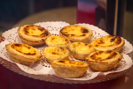 Assorted Pastel De Nata Pastries Elegantly Displayed on a Lace Doily