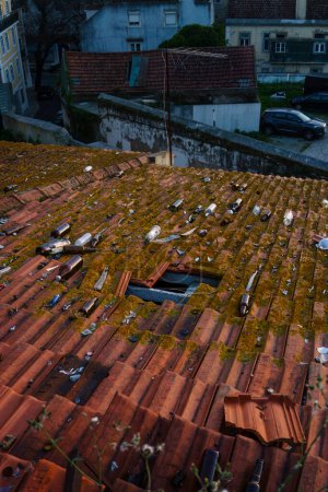 Photo for Debris on a red tile roof in Lisbon, Portugal February 2, 2024. - Royalty Free Image