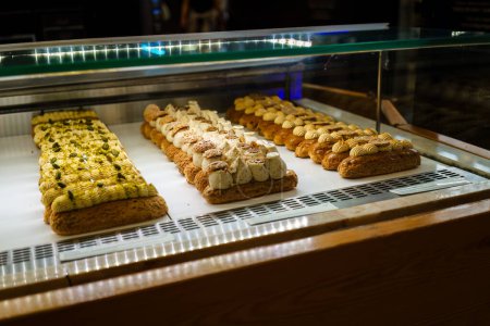 Rows of crafted pastries in a bakery display case