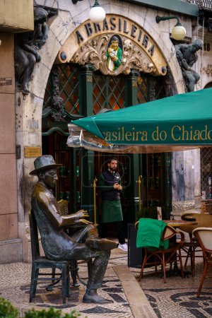 Photo for Statue of a Man Sitting at a Table in Front of A brasileira do chiado. Lisbon, Portugal. February 2, 2024. - Royalty Free Image