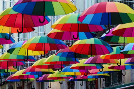 Close up of the colorful umbrellas over Calle Rosa, the pink street in Lisbon, Portugal