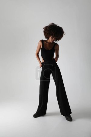 Beautiful African American woman looking at camera. Portrait of cheerful young woman with afro hairstyle. Beauty girl with curly hair. High quality photo