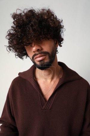 Vertical portrait of casual guy, with curly hair. Mind set and mental health. High quality photo.