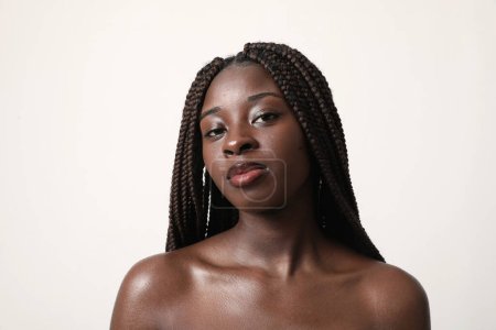 Photo for Beautiful young African American woman confidently looks at camera. Isolated. High quality photo. - Royalty Free Image
