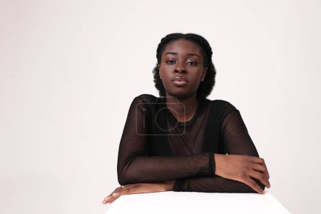 Beautiful young African American woman confidently looks at camera. Isolated. High quality photo.