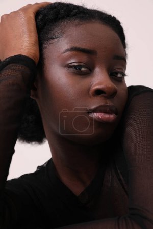 Indoor portrait of confident African American woman looks at camera. Mock-up. High quality photo.