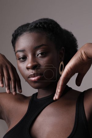 Photo for Indoor portrait of confident African American pretty woman looks at camera. Mock-up. High quality photo. - Royalty Free Image