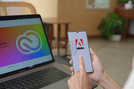 Photo for Chiang Mai Thailand. Jul 09, 2022. woman holding mobile phone to open adobe creative cloud to create work, photo, video, template, pdf - Royalty Free Image