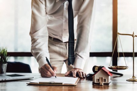 Reading the contract and signing the real estate purchase, the buyer is reading the important documents before entering into a building buy agreement with the agent.