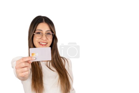 Photo for Showing credit card, portrait of fashionable modern businesswoman showing credit card. Isolated white background, copy space. Secure online shopping via internet. Caucasian brunette lady with glasses. - Royalty Free Image
