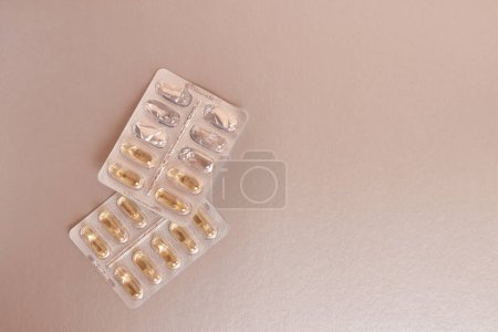 Photo for Vitamins in the form of capsules on a silver background. Treatment and prevention of diseases. Strengthening immunity. - Royalty Free Image