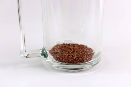 To prepare a decoction, flax seeds are poured into a glass. Medicinal properties of flax.