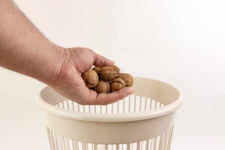 Expired nuts are thrown into the trash. Processing of food waste.