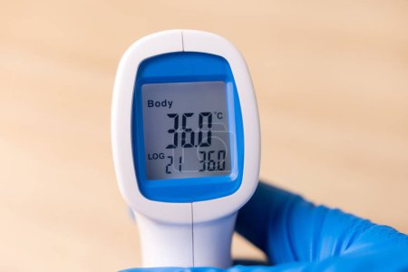 Human body temperature is measured with a remote thermometer.