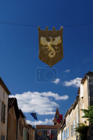 Photo for Medieval flag with dragon, during medieval festival in Monpazier, Dordogne - Royalty Free Image
