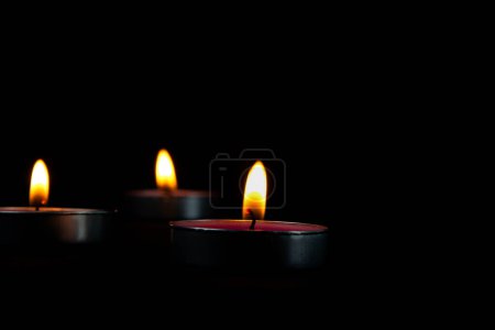 Photo for Three candles lighting and candle with yellow flame in the dark, a Light of candle in the dark. - Royalty Free Image