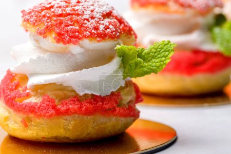 Shu cake. Custard dessert with creamy white cream, decorated with raspberries.