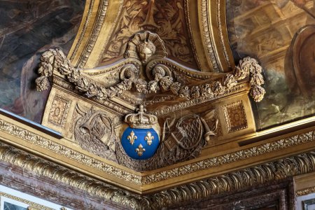 Photo for VERSAILLES, FRANCE - SEPTEMBER 8, 2019: This is a corner ceiling molding with symbols of royal power in the Diana Room of the Palace of Versailles. - Royalty Free Image