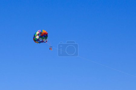 Photo for BARSELONA, SPAIN - MAY 13, 2017: These are unidentified people in a parachute flight while doing parasailing. - Royalty Free Image
