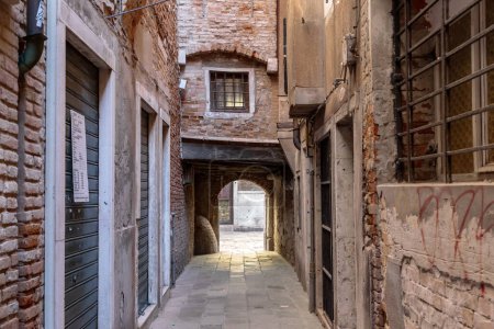 Photo for VENICE, ITALY - MARTH 12, 2023: This is a passage in a narrow lane of a non-tourist residential part of the old city. - Royalty Free Image