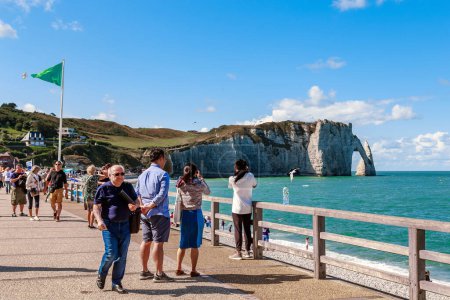 Photo for ETRETAT, FRANCE - SEPTEMBER 1, 2019: This is a view of the lively promenade of town and the cliff d'Aval on the Alabaster Coast of Normandy. - Royalty Free Image