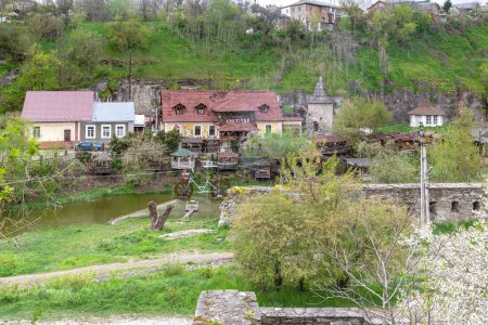 Photo for KAMENETS-PODOLSKY, UKRAINE - APRIL 26, 2023: These are the remains of the Polish Gate fortifications and a modern recreation center with a restaurant on the Smotrich River. - Royalty Free Image