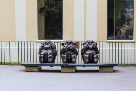 Photo for VIENNA, AUSTRIA - MAY 14, 2019: This is a sculptural bronze group Three Monkeys on the bench of Zoo. - Royalty Free Image
