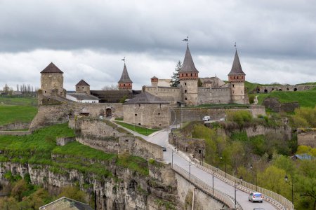 Photo for KAMENETS-PODOLSKY, UKRAINE - APRIL 26, 2023: This is a view of the castle bridge and medieval castle on a cloudy spring evening. - Royalty Free Image