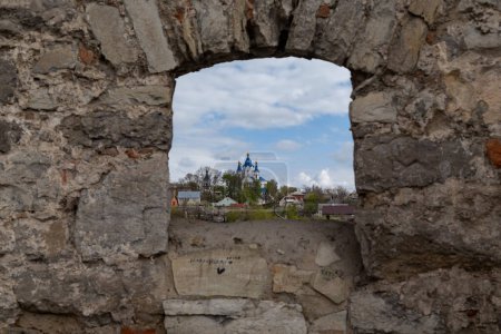 Photo for KAMENETS-PODOLSKY, UKRAINE - APRIL 27, 2023: This is a view of St. George's Church through the loophole of the outer walls of the fortress/ - Royalty Free Image