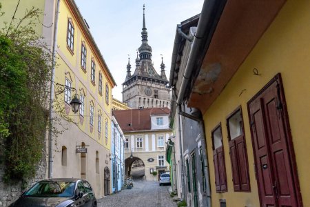 Photo for SIGHISOARA, ROMANIA - MAY 2, 2023: This is the street of the old town that leads to the passage to the gate of the Clock Tower of the medieval citadel. - Royalty Free Image