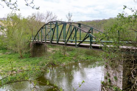 Photo for KAMENETS-PODOLSKY, UKRAINE - APRIL 27, 2023: This is a pedestrian bridge across the Smotrich River in a suburban development. - Royalty Free Image