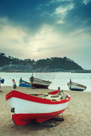 Photo for Boats stand on the beach against the backdrop of the sea. Morning seascape. Daylight, selective sharpness - Royalty Free Image