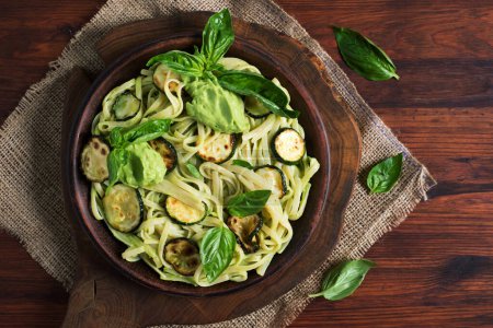 Photo for Bright and delicious vegetarian pasta with zucchini in avocado sauce - Royalty Free Image