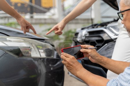 A male car insurance agent using his phone to take picture of the car scratch marks from the accident while the male and female car owners pointing them out for him
