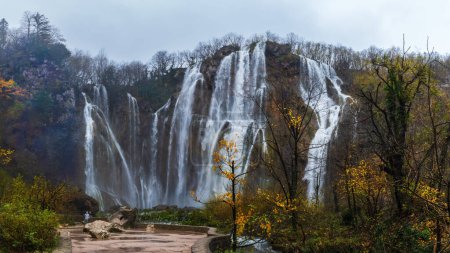 Photo for Panoramic view of the beautiful Great Waterfall in Plitvice National Park in Croatia on an autumn day green, yellow foliage and turquoise water. Travel photo - Royalty Free Image