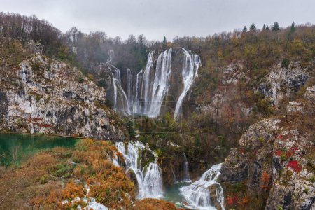 Photo for Great Waterfall in Plitvice National Park in Croatia on an autumn day, yellow foliage and turquoise water. Vertical panorama - Royalty Free Image