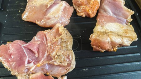 Healthy eating, cooking poultry on an electric grill, with various spices